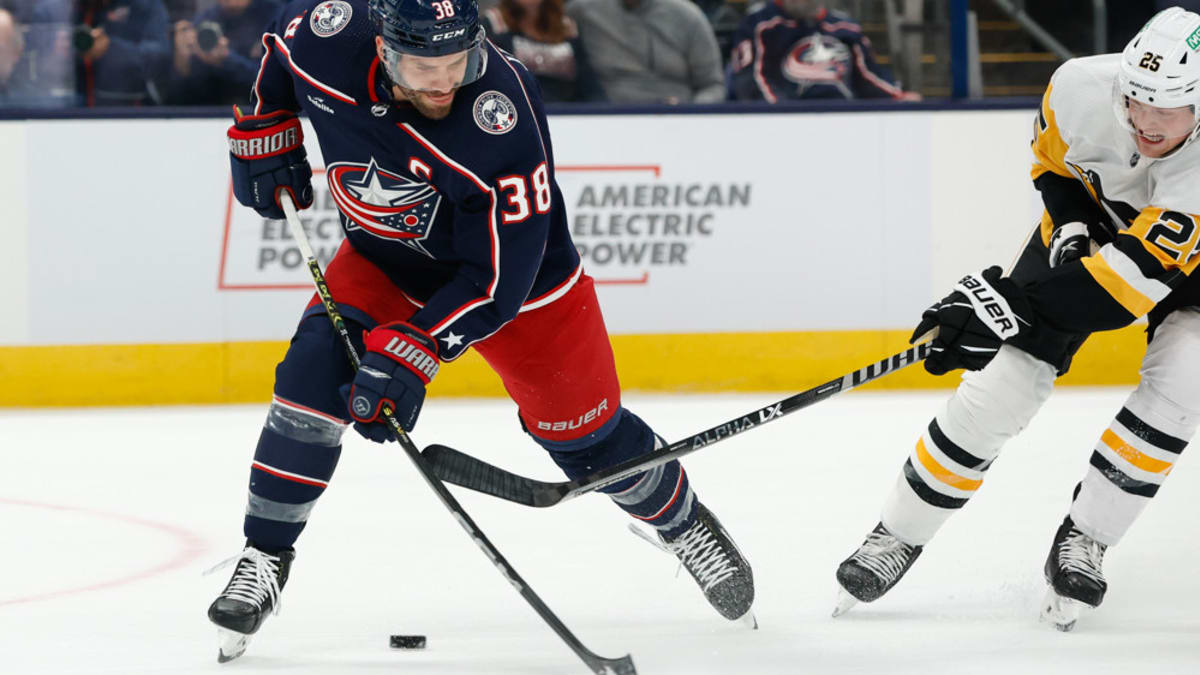 Boone Jenner Columbus Blue Jackets Unsigned White Jersey Skating with Puck  vs. Nashville Predators Photograph