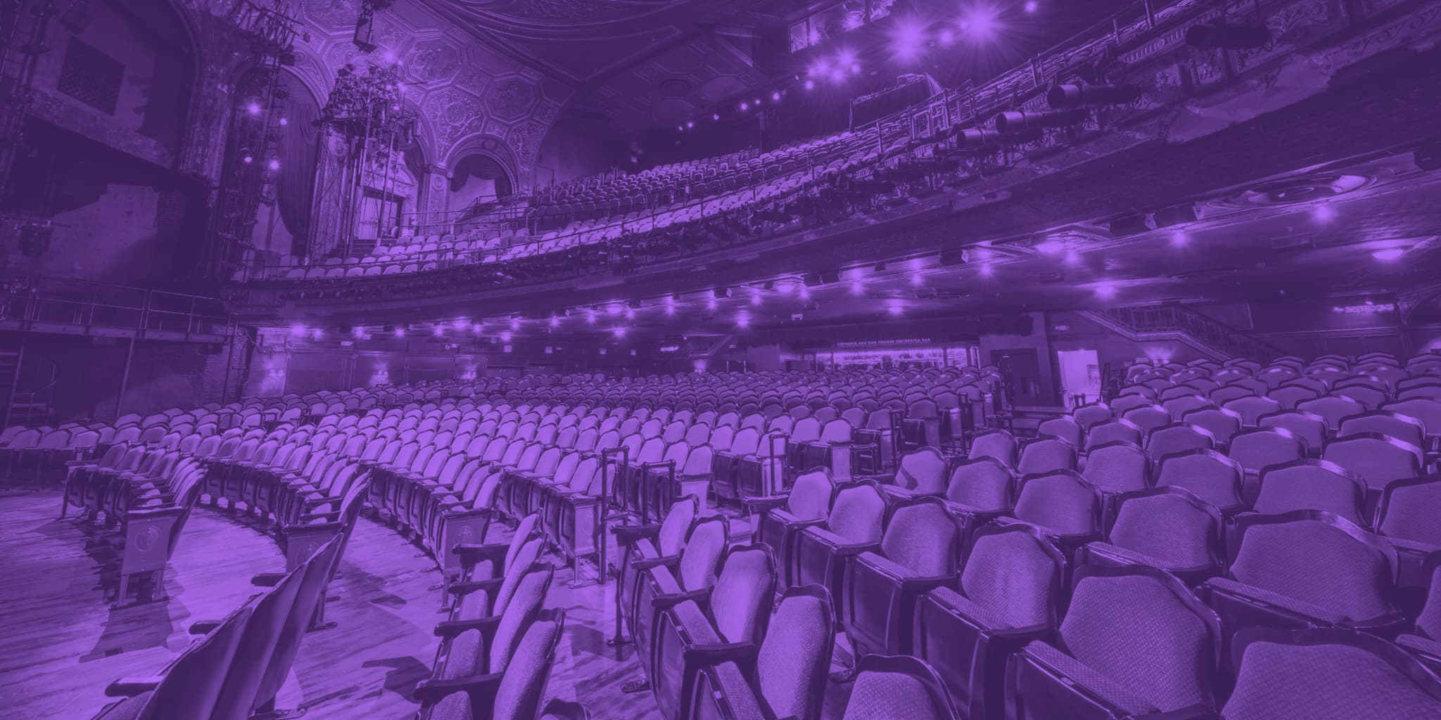 A purple-tinted picture of an empty theatre.