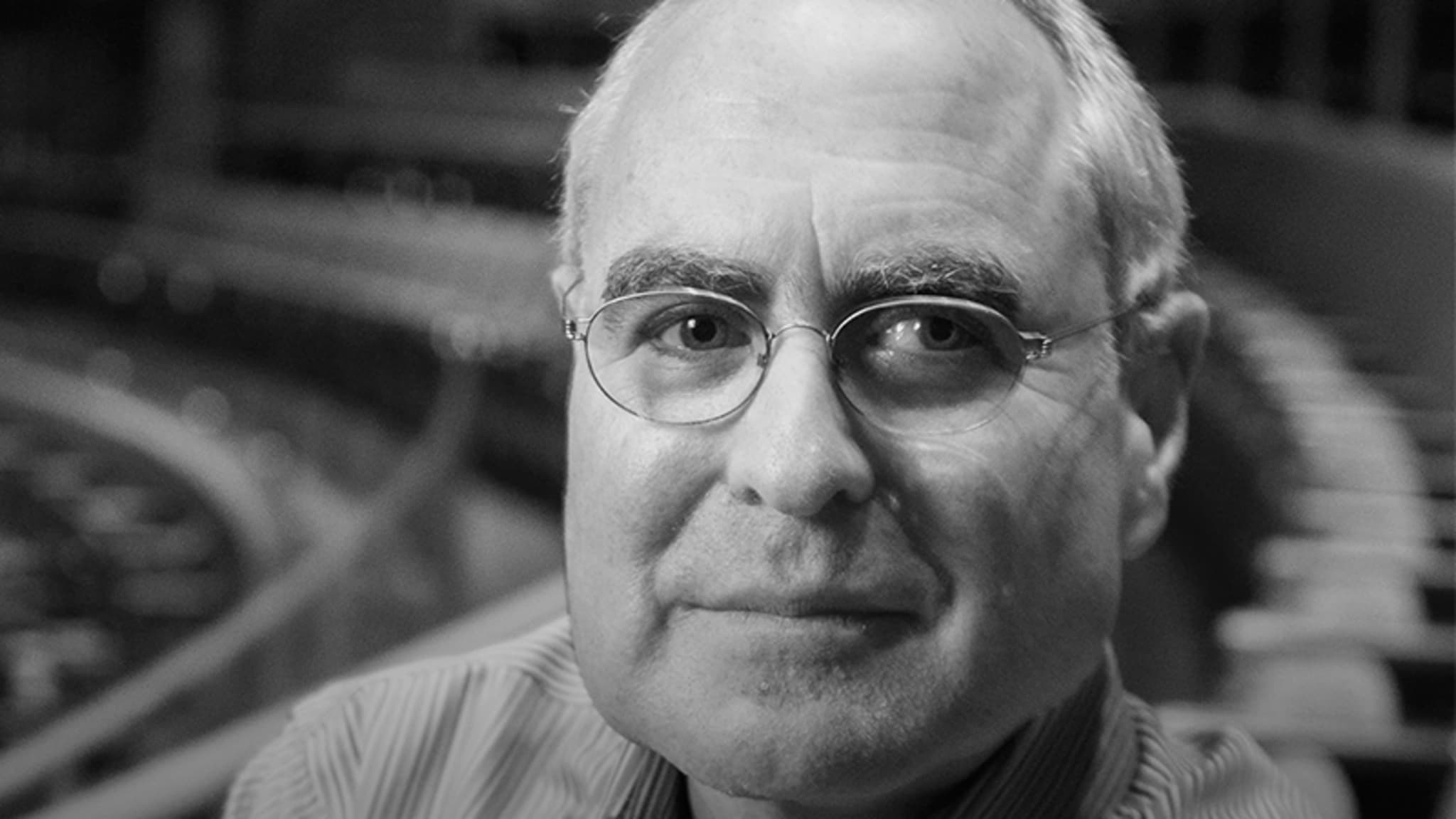 Black and white image of Todd Haimes sitting in an empty theatre.