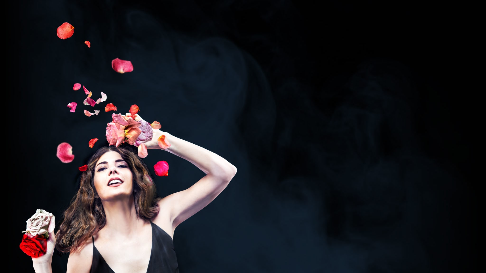 Artwork for The Rose Tatto. Marisa Tomei in a black tank top poses with a cascade of roses in her hands and flying around her.