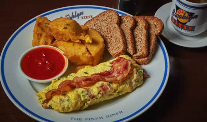 A Brooklyn diner plate with an omlette, potatoes, toast, and ketchup. 