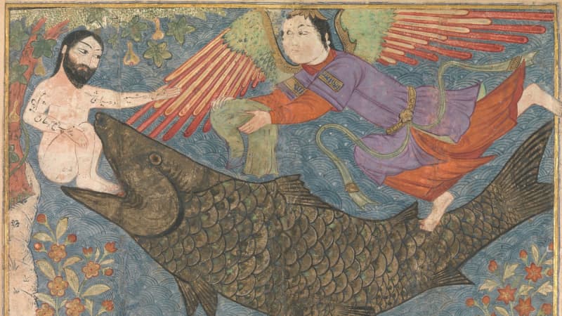 A large, greenish-brown fish holds a nude, light-skinned man with dark hair and a dark beard in his jaws. An angel, clad in purple and orange robes, reaches toward the nude man.