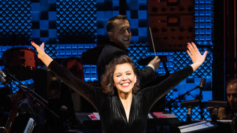 Maggie Gyllenhaal takes her bow. She wears a black velvet top tucked into black pants.