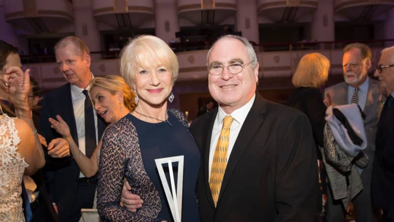 Helen MIrren, holding an award, poses for a photo with Todd Haimes.