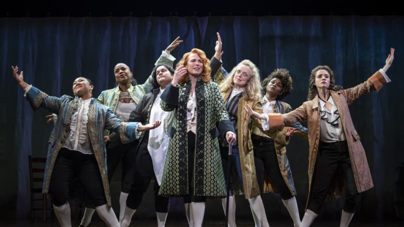 Actors in the song "Cool, Cool, Considerate Men," clumped into a pyramid formation with their arms outstretched, highlighting the actor at the center, Carolee Carmello.