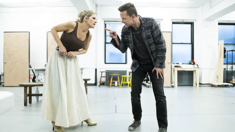 A woman and man in the rehearsal studio look like they're dramatically arguing.