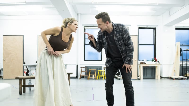 A woman and man in the rehearsal studio look like they're dramatically arguing.