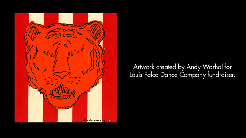 Artwork created by Andy Warhol for Louis Falco Dance Company fundraiser. The head of a tiger drawn in black lines on an orange-red surface. The background is red and white horizontal stripes. 