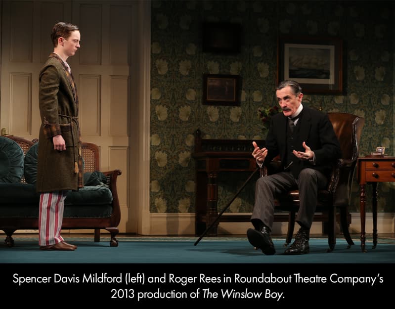 Spencer David Mildforod and Roger Rees in THE WINSLOW BOY. A teenage boy in old fashioned pajamas stands and looks at an older man in a dark, old fashioned suit.