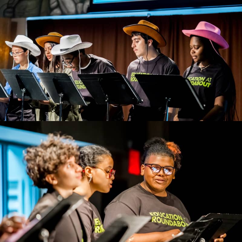 The Roundabout Youth Ensemble on stage with music stands. Several students are wearing cowboy hats. 