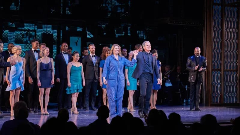 The cast of MY ONE AND ONLY at curtain call. A man and woman take their bow holding hands.