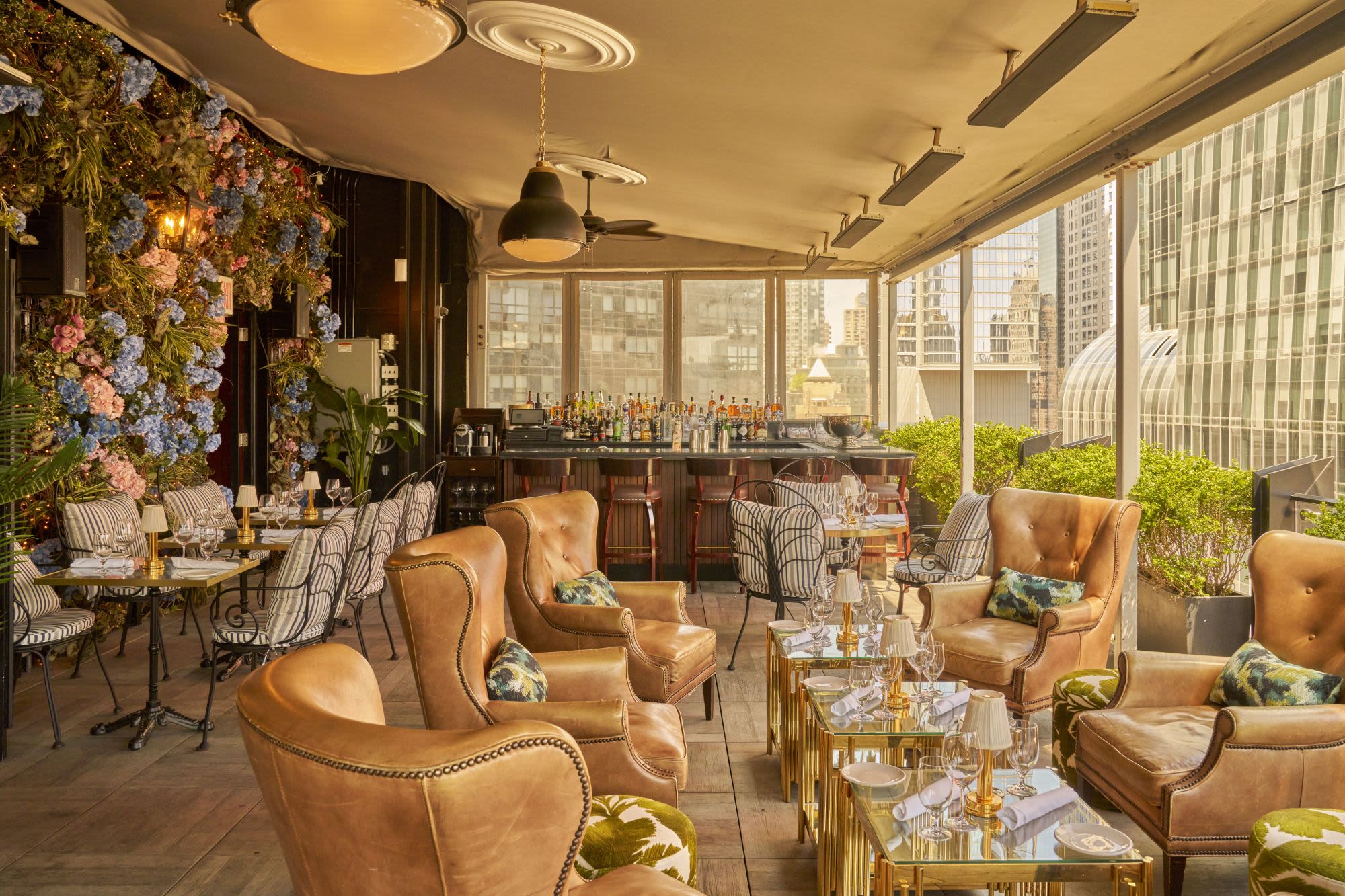 Le Jardin's well lit interior featuring tan leather seats and floral arrangements