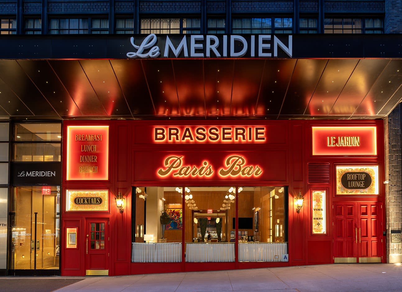Exterior shot of Paris Bar with various neon signs