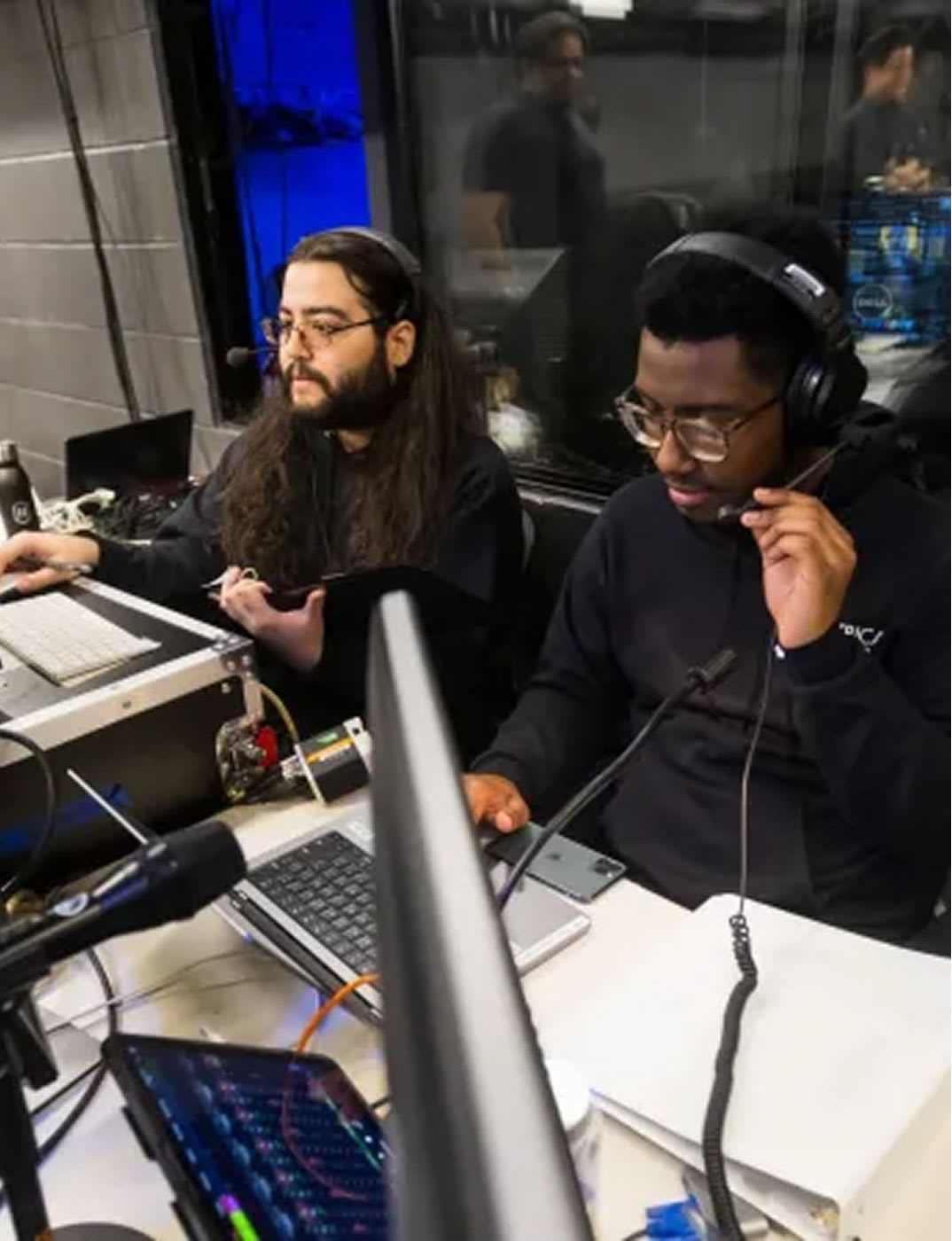 Students use headsets and technical equipment while managing audio during a Roundabout Theatre Company education program.