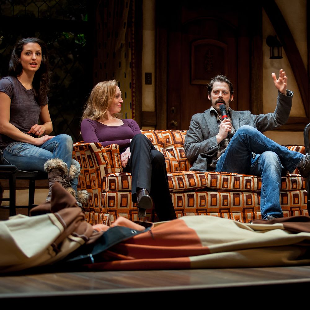 Actors sit on a couch on stage speaking with microphones during a Roundabout Theatre Company celebrity discussion series.