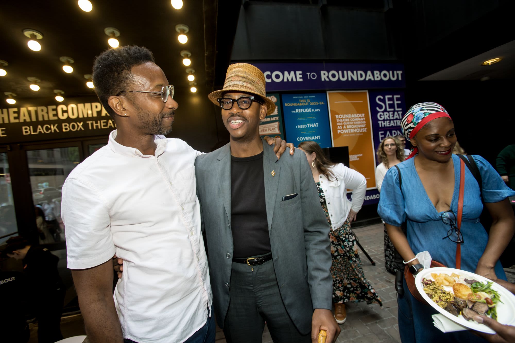 Guests gather and laugh near the entrance of Roundabout Theatre Company's Black Box Theatre during a Black Theatre Night reception for Primary Trust.

