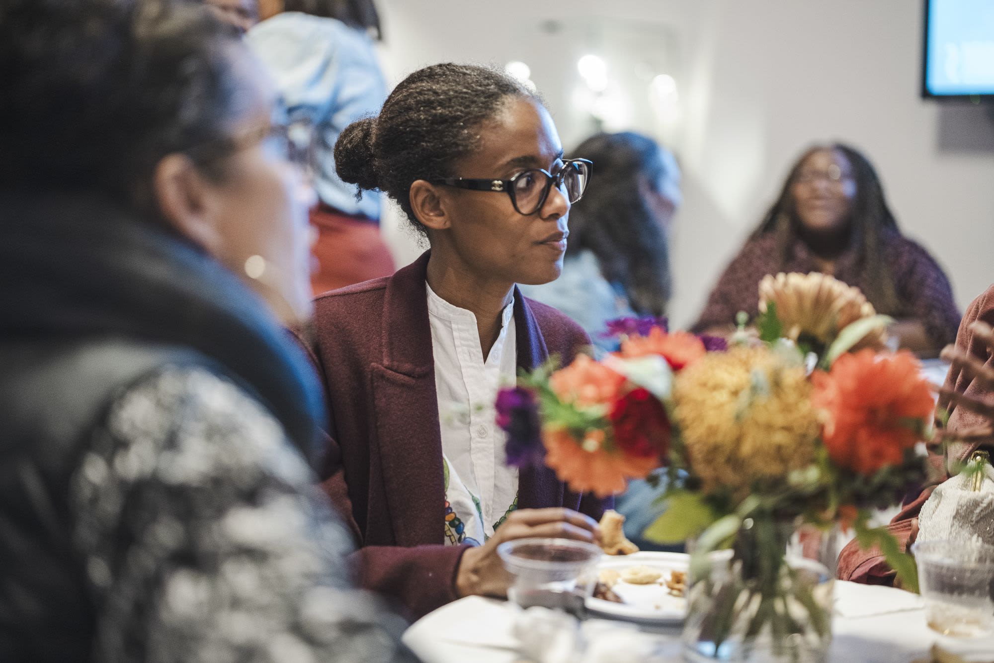 A guest listens attentively during a Black Theatre Night dinner event for The Refuge Plays at Roundabout Theatre Company.