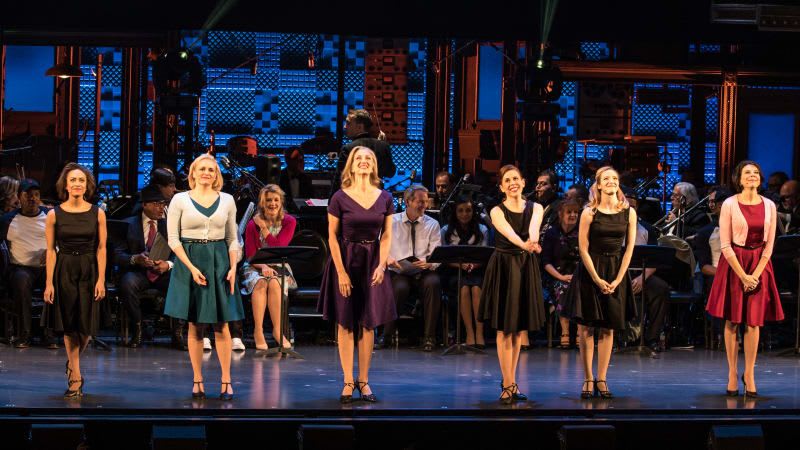 The cast of DAMN YANKEES at curtain call. A line of women in dresses takes their bow.