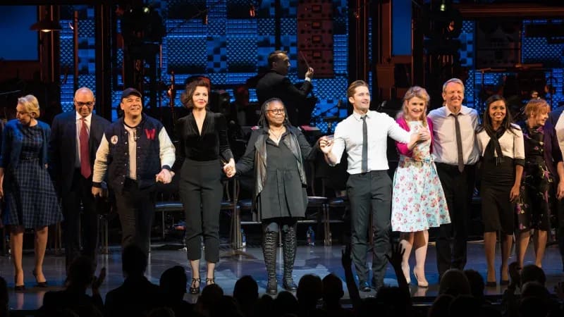 The cast of DAMN YANKEES holds hands during the curtain call.