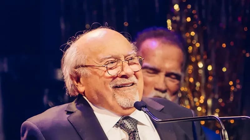 Danny DeVito accepting an award. 