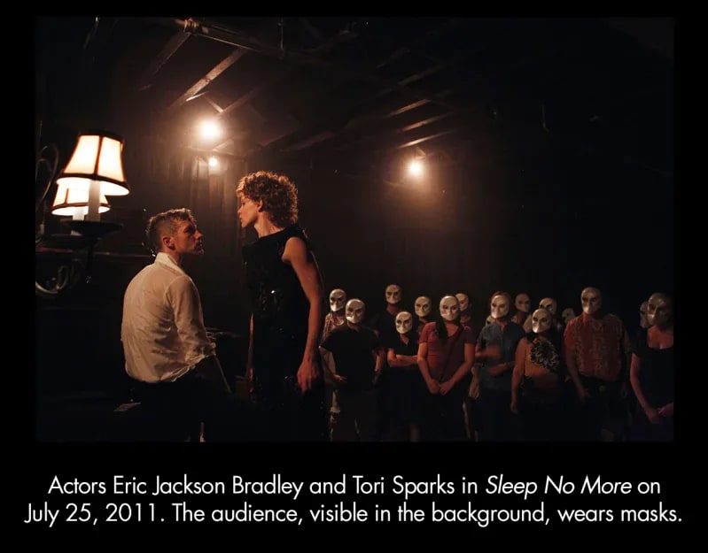 Actors Eric Jackson Bradley and Tori Sparks in Sleep No More on July 25, 2011. The audience, visible in the background, wears masks.