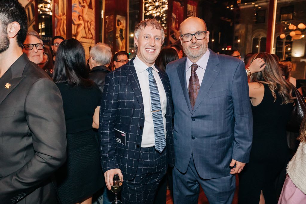 Two people posing for a picture in formal wear