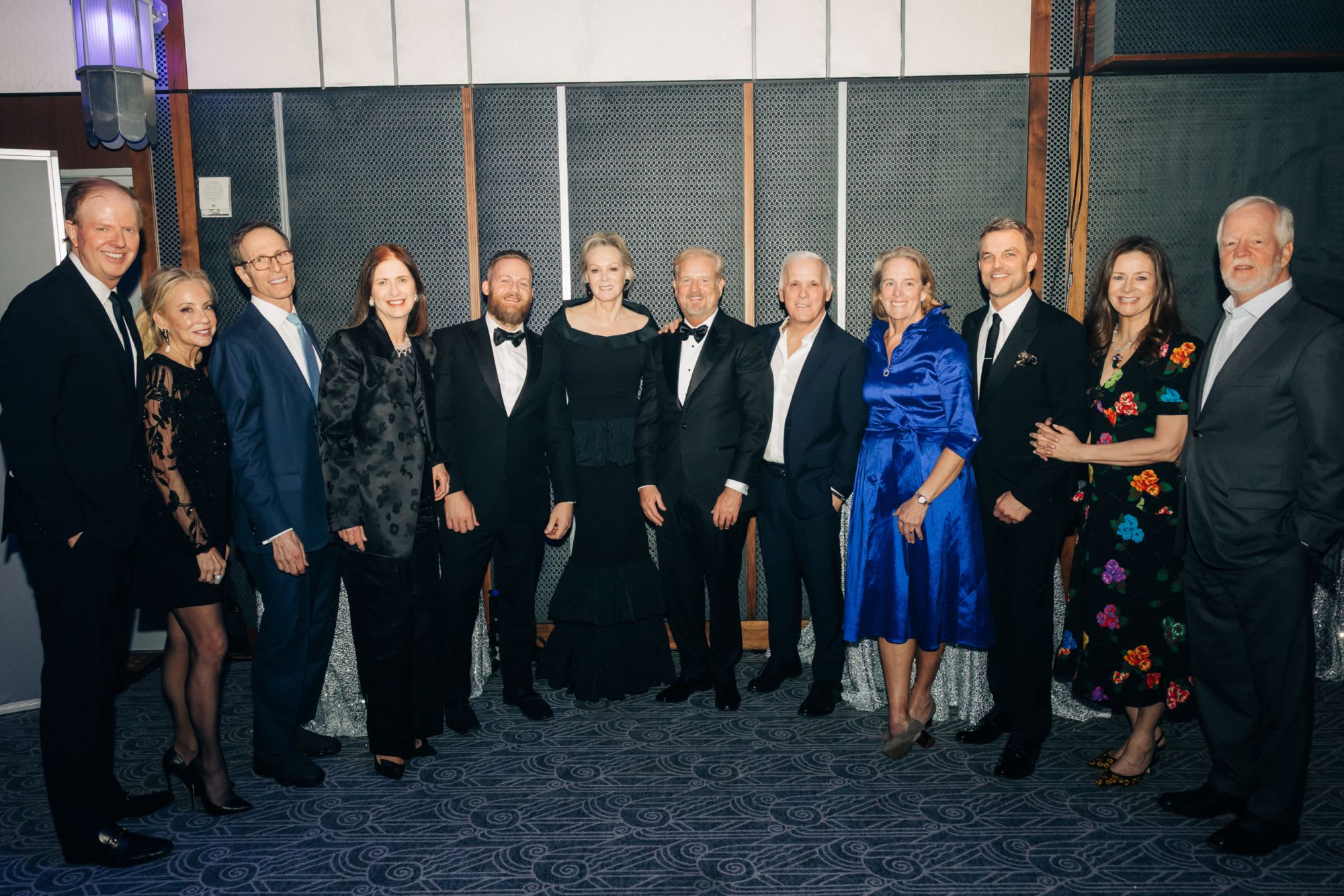 Guests in formal attire post for a photo at 2026 Roundabout Gala.