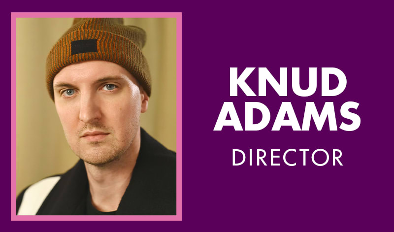 Knud has light skin, blue eyes, and wears a black coat and brown beanie hat.