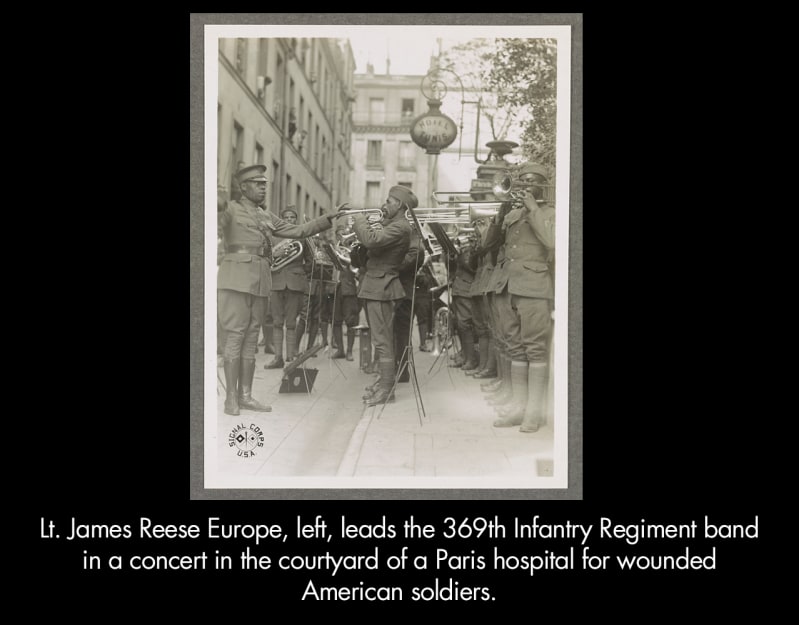 Lt. James Reese Europe left leads the 369th Infantry Regiment band in a concert in the courtyard of a Paris hospital for wounded American soldiers.