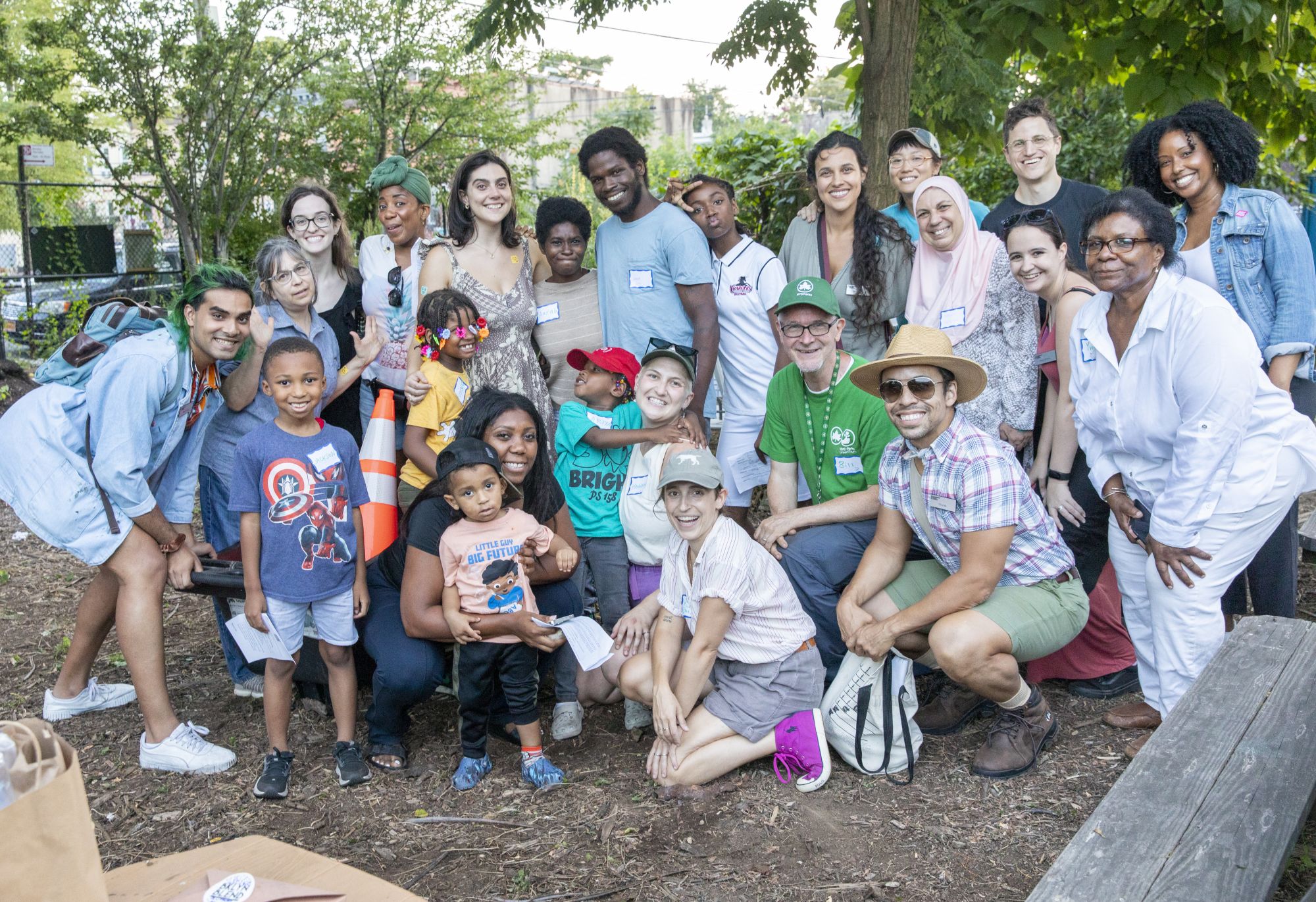 A group of participants huddle together for a photo at a community garden workshop.