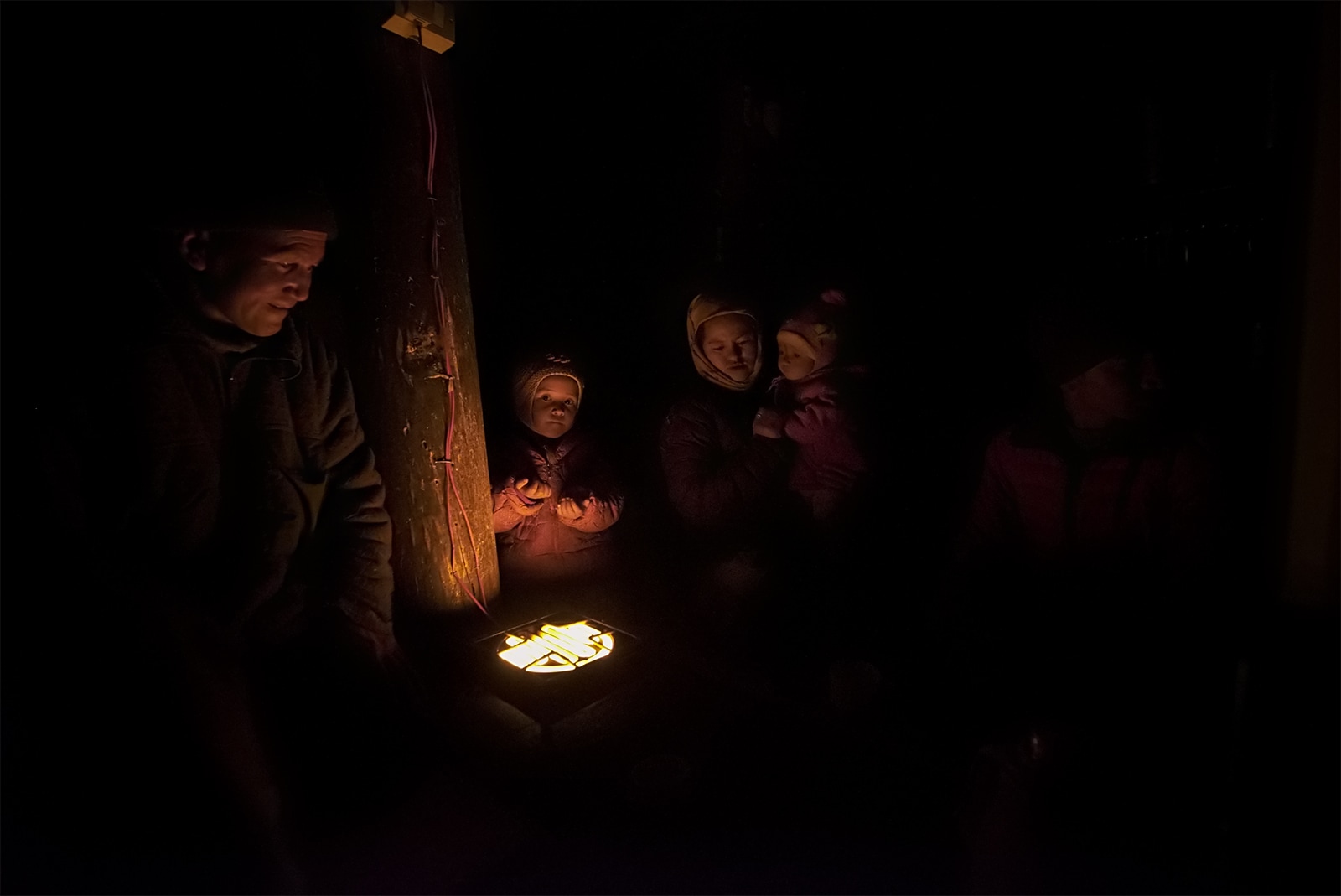 Temperatures may drop well below -30 degrees Celsius in Ulley. Family members gather around an electric heater for warmth. Photo: Pankaj Singh