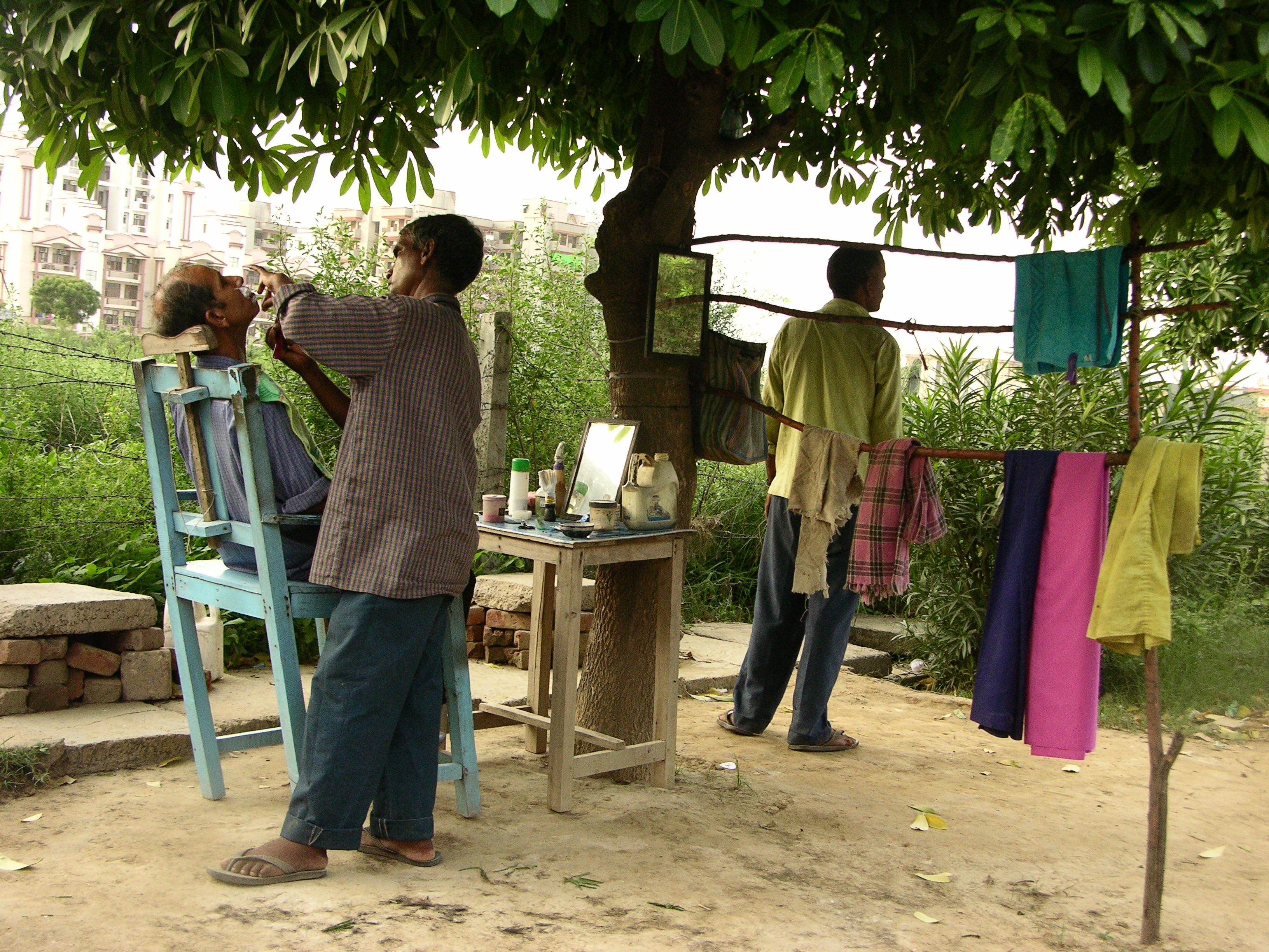 Early morning a bag opens and all its contents are emptied on a table, and within minutes the shop is open to customers. No stuffy interiors. All the hair is collected and conveniently shoved into wild grass where it turns into organic goo.

