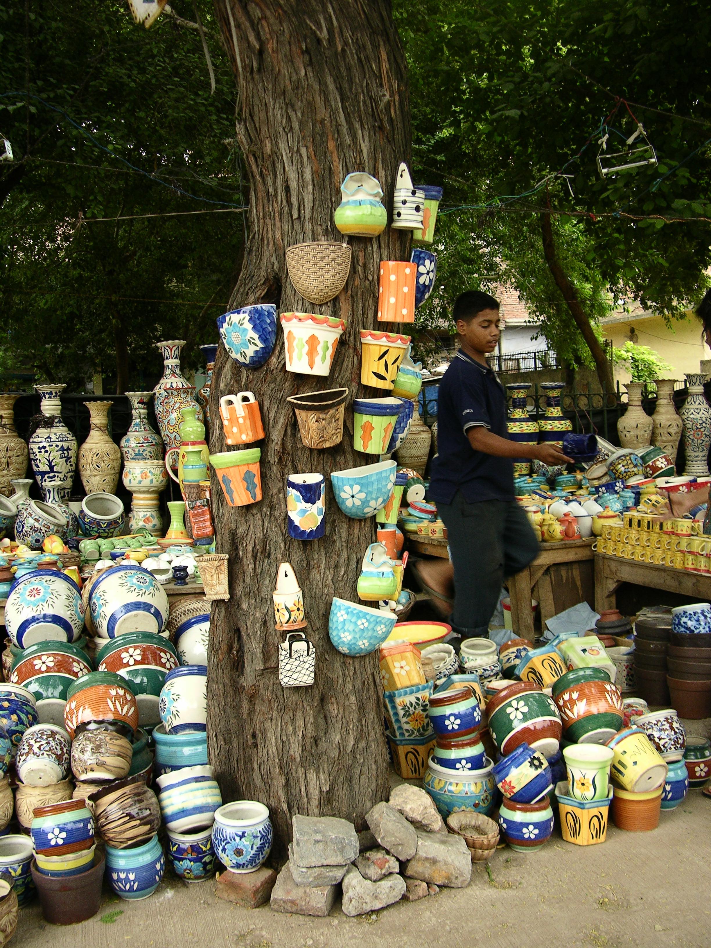 Wires, nails, extension boards, display lighting and wares to sell. What else does one need to set up shop? Floor space? Easy — as wide as the tree’s shadow.