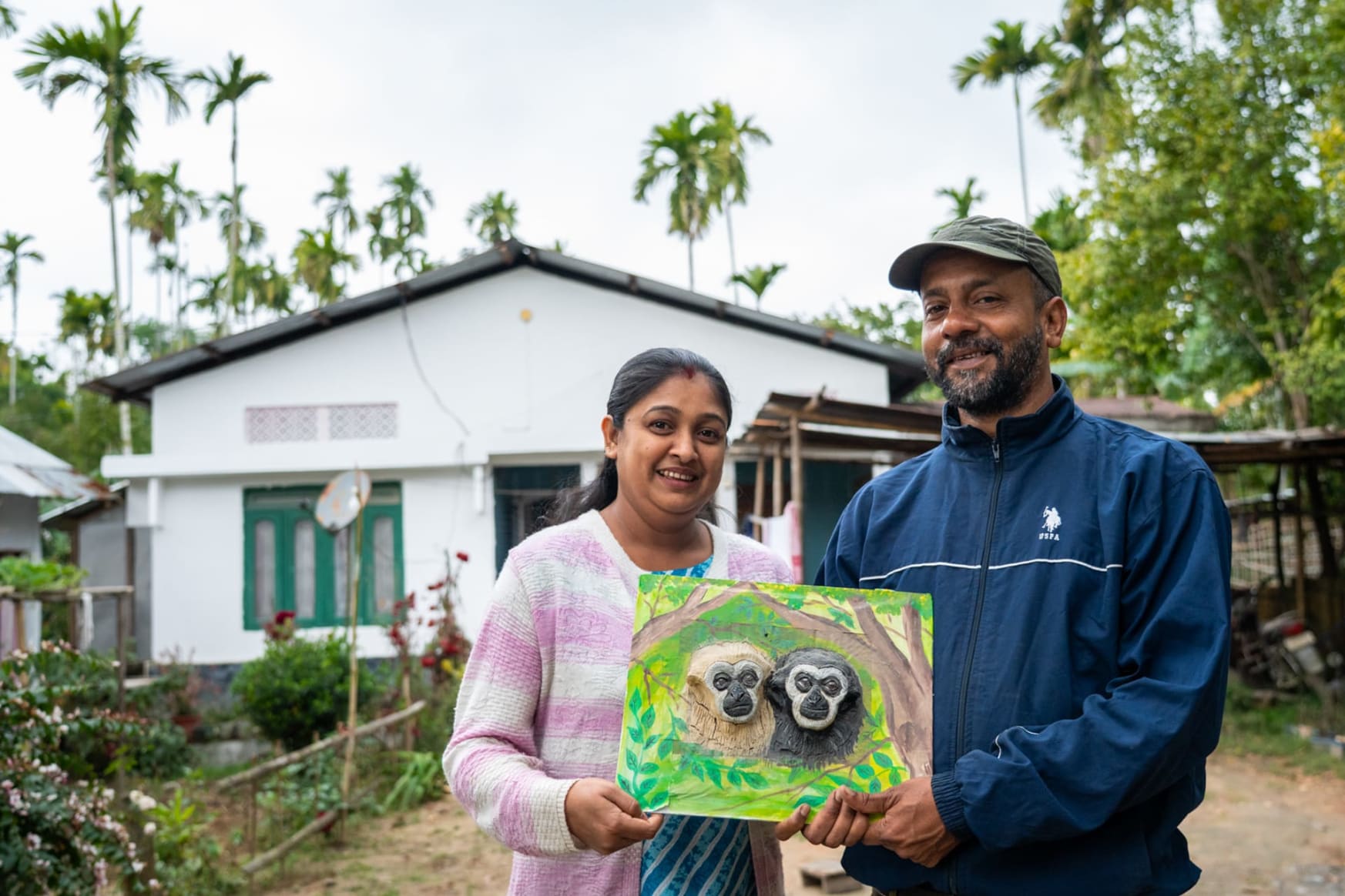 Pinak Borthakur holdoing a painting of holoock gibbons Hollongapar Gibbon Wildlife Sanctuary in Assam