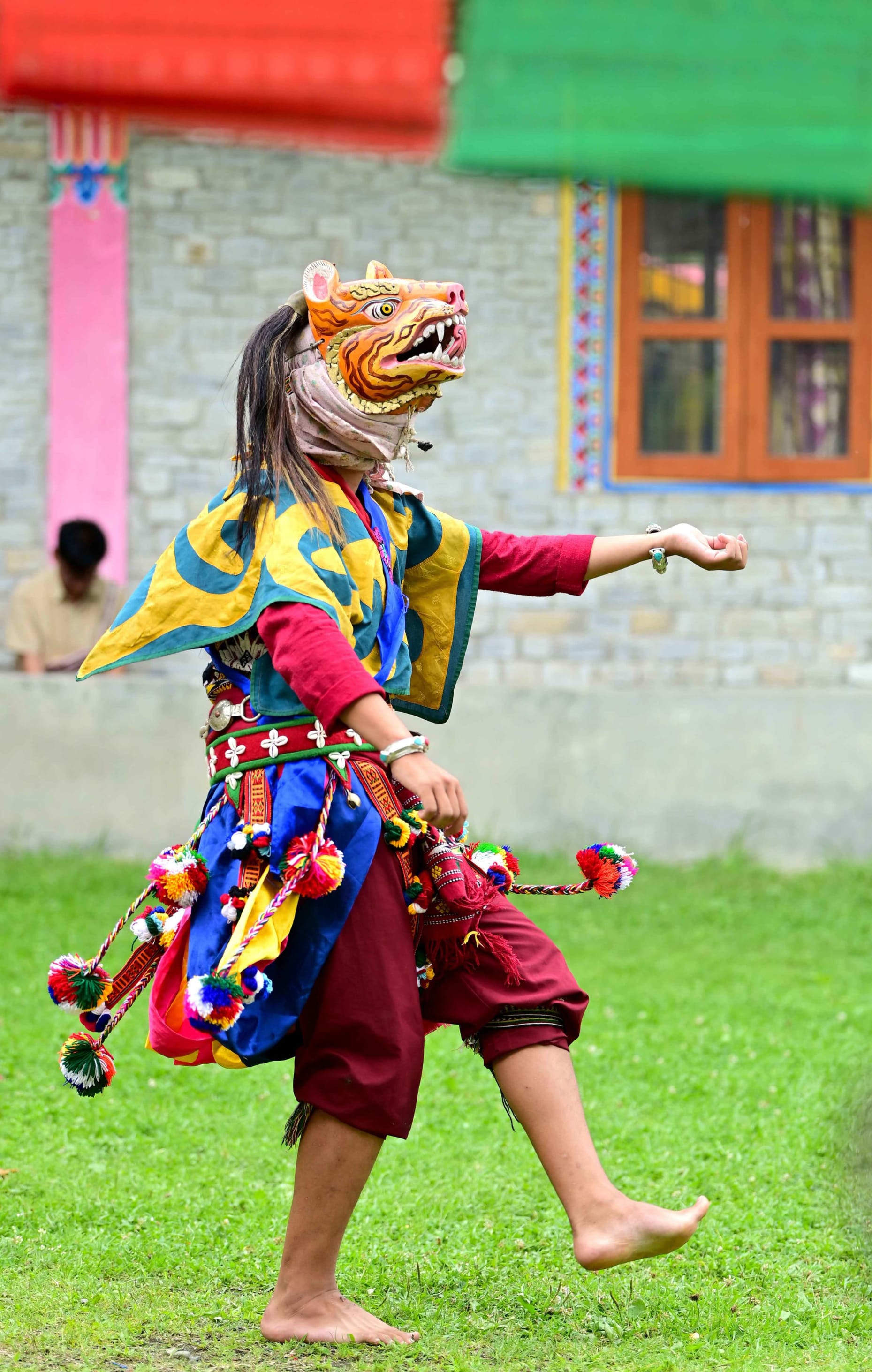 A masked dancer of Bardo Cham in Shergaon, Arunachal, in colourful, traditional attire.