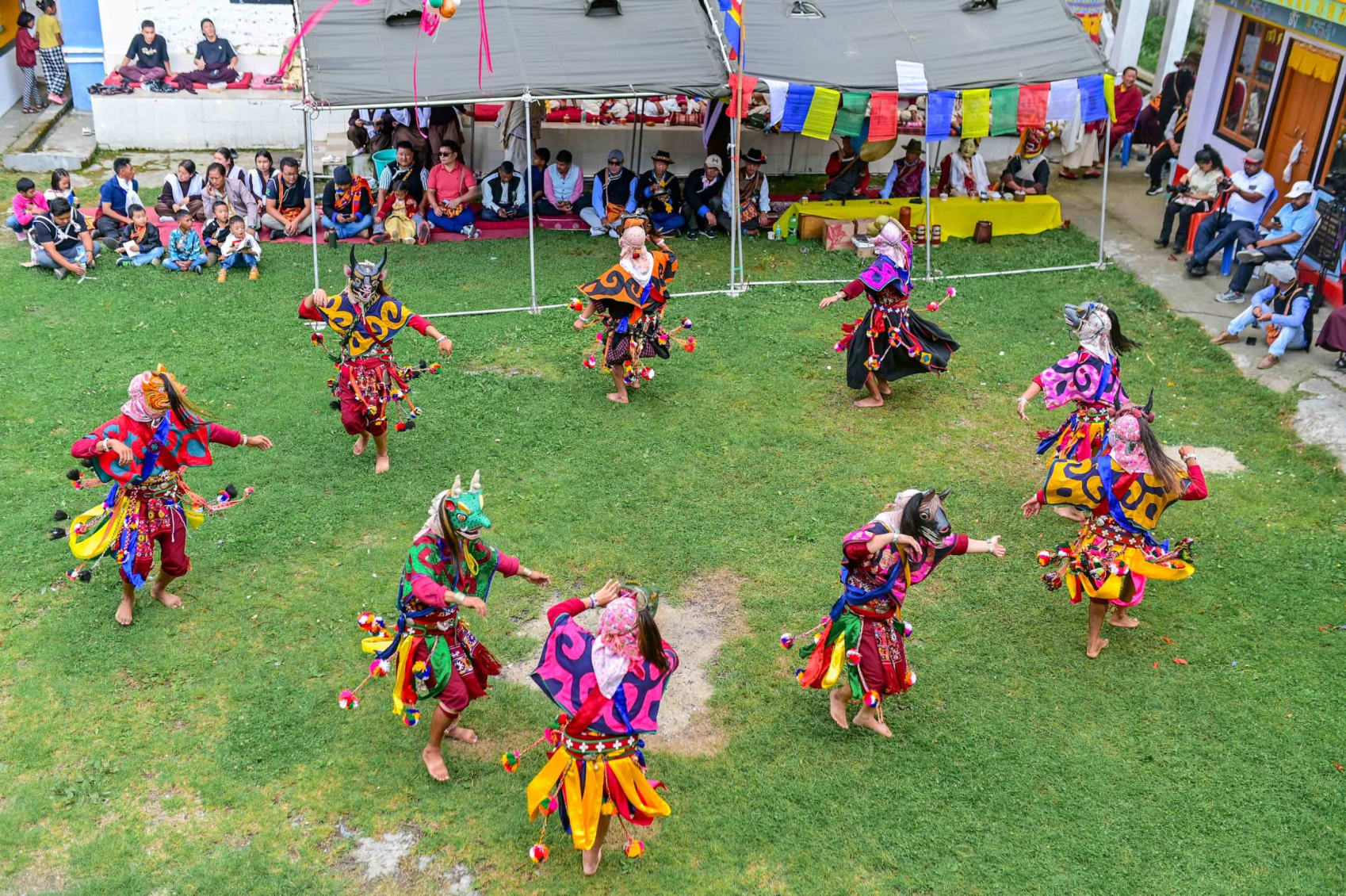 Masked dancers dancing in Bardo Cham, Shergaon, Arunachal, in colourful, traditional attire.