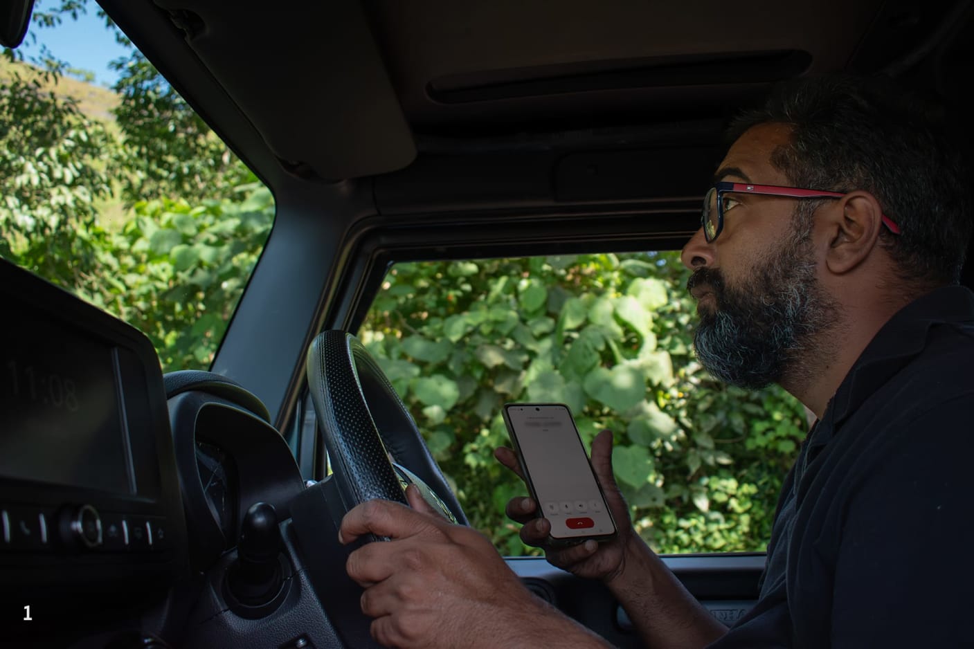 While driving his Thar, Ganesh scans the area for elephants and receives updates over phone calls from field watchers and locals.