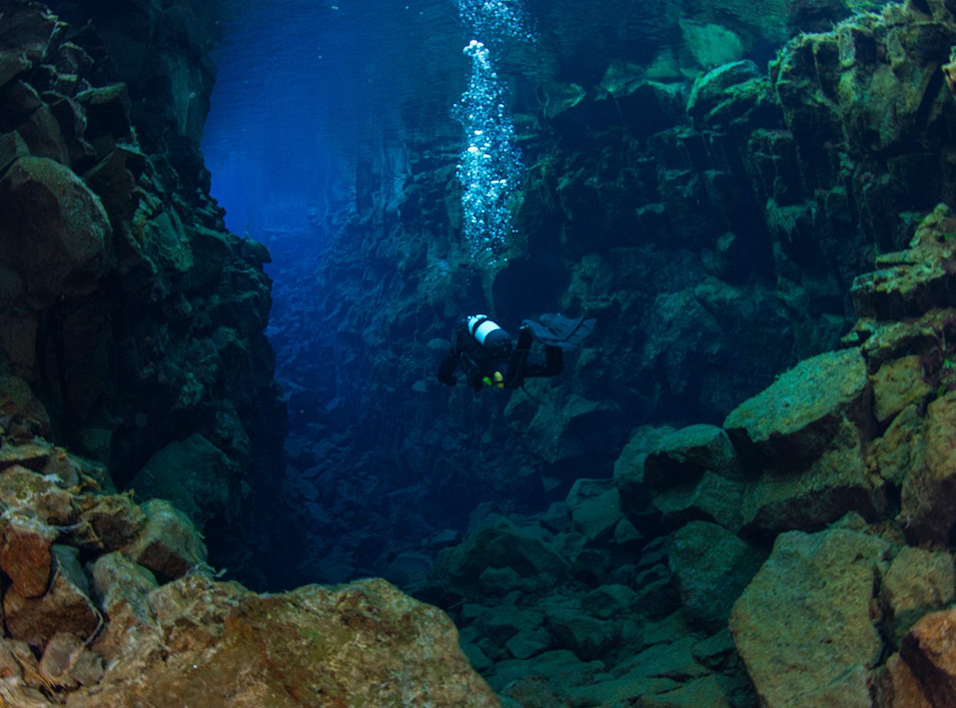 Thingvellir National park is a UNESCO World Heritage site where the Mid-Atlantic Rift is visible. It is a historically and culturally significant place for Icelanders, and an area of great natural beauty. At Silfra, a deep chasm divides the continental plates of Europe and North America. This fissure was formed during an earthquake in 1789 and the two plates continue to drift apart approximately 2 cm each year. I went scuba diving here, where the water was crystal clear and visibility at least 50 metres. Only rocks and green hairy algae were visible as fish seem not to venture into its depths. 
