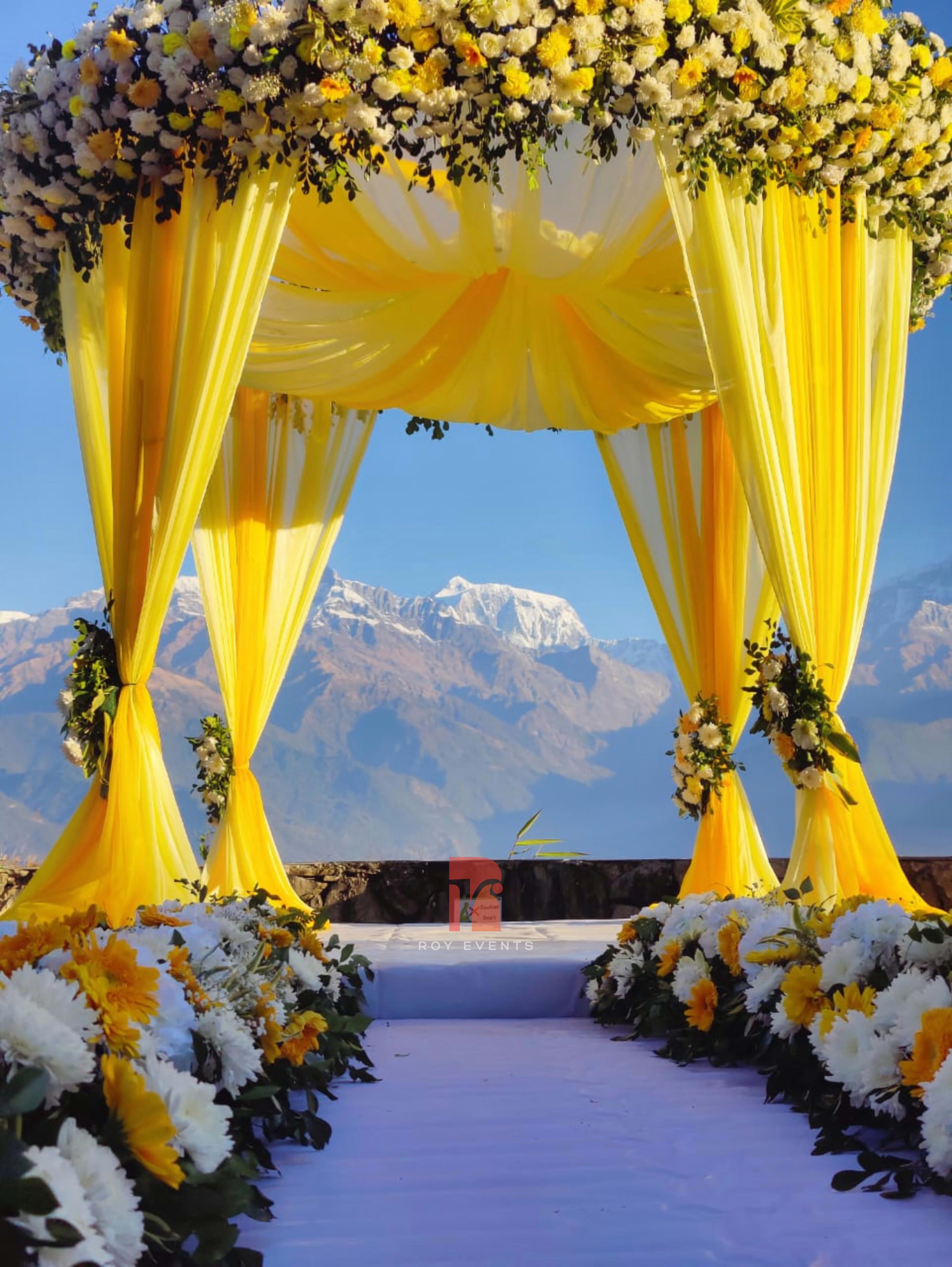 Mountain Meadow Elegance: Yellow Mandap with Floral Accents