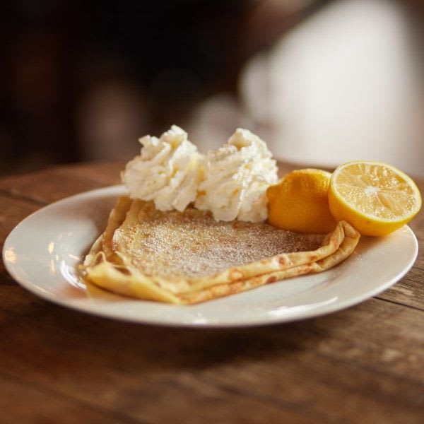 A lemon crepe garnished with whipped crème