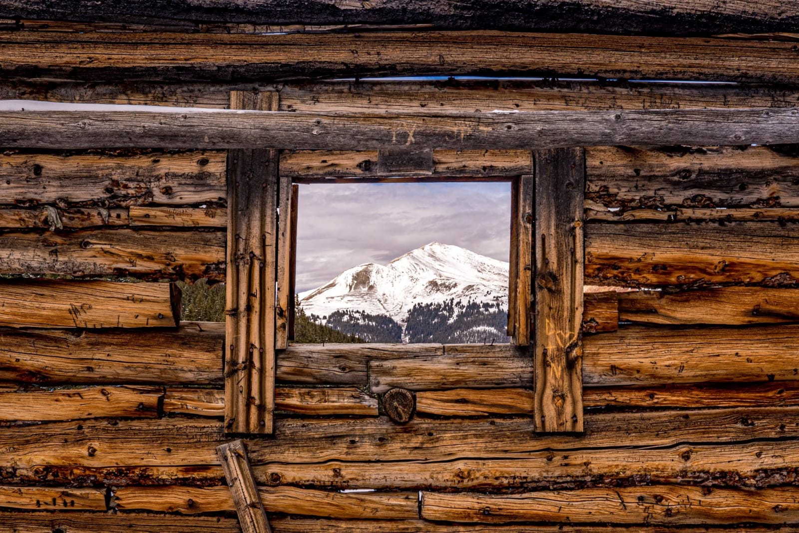Best Picture Frame in Summit County — Mayflower Gulch, Colorado. Hand-hewn logs framing the snowy basin the miners came to Mayflower Gulch for in the first…