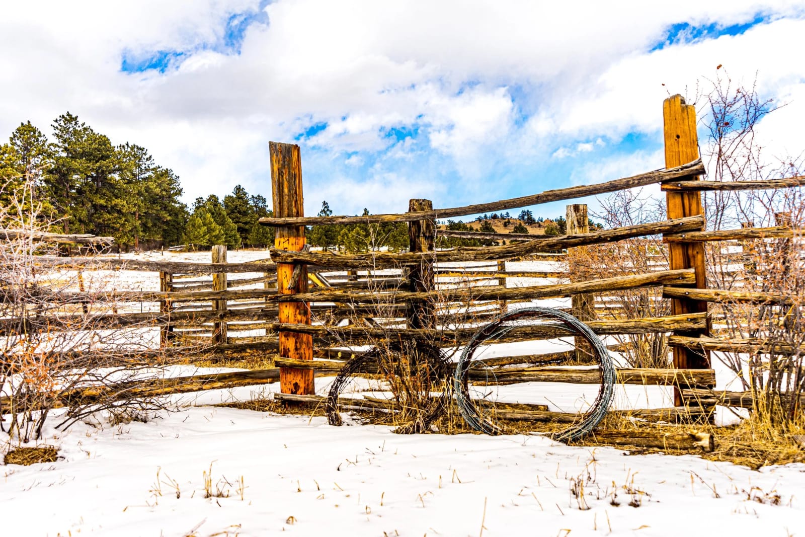 A Wheel That Stopped Turning — Clear creek canyon. An old corral and a wagon wheel that has not turned in decades, half buried in snow in Colorado ranch…