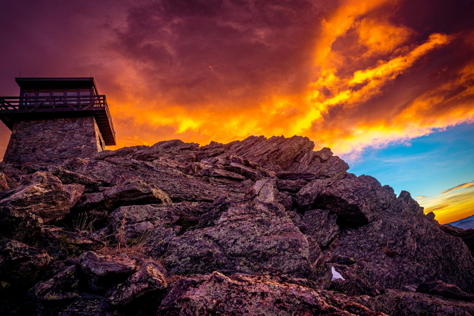 A Fitting Spot for It — Mestaa'ehehe Mountain, Colorado. An old fire lookout keeping its silhouette while the sky does its best impression of a wildfire,…