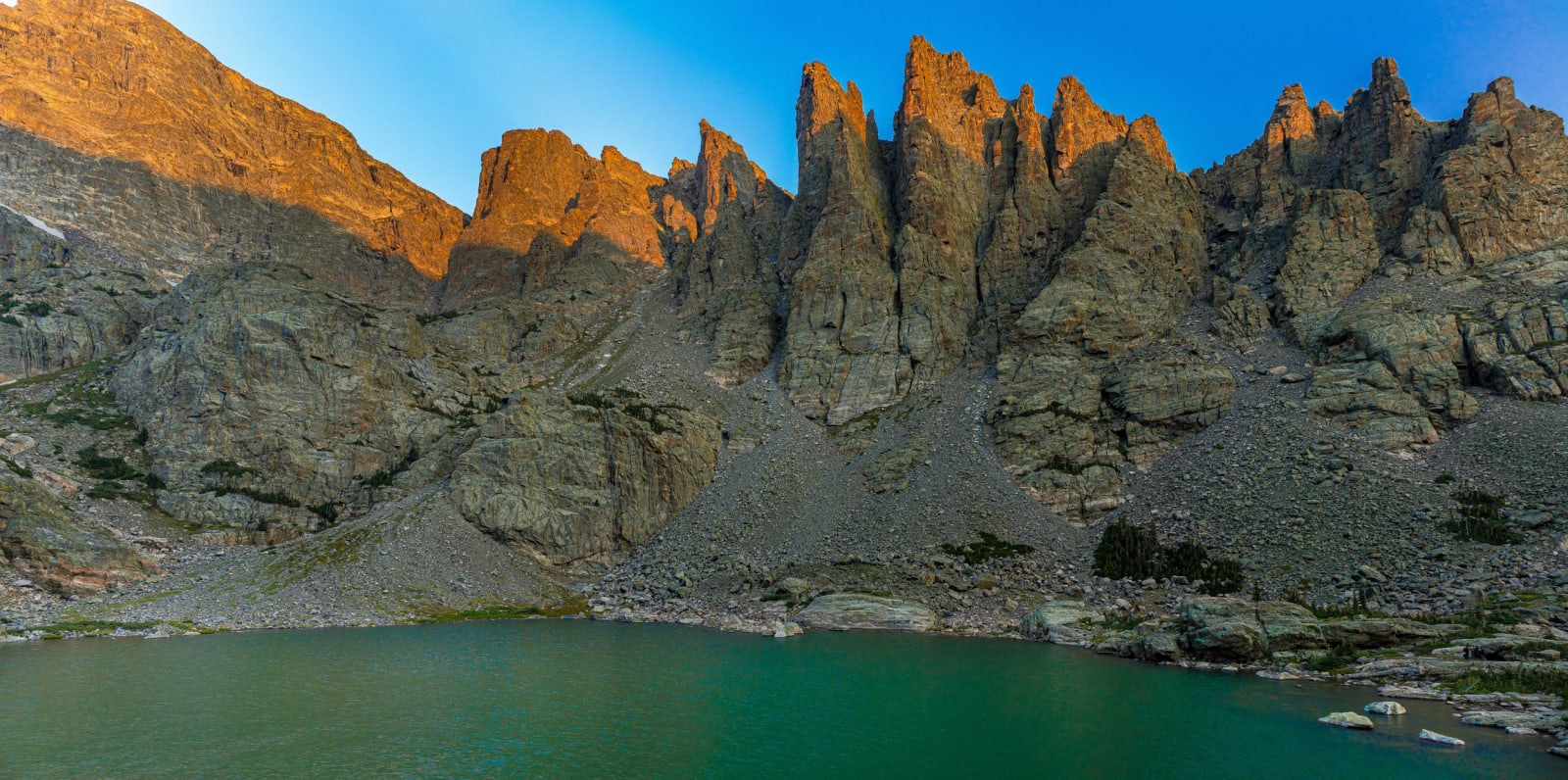 The Sharkstooth Catches Sun — Rocky Mountain National Park, Colorado. The Sharkstooth catching morning sun while Sky Pond waits in the shade below, deep…