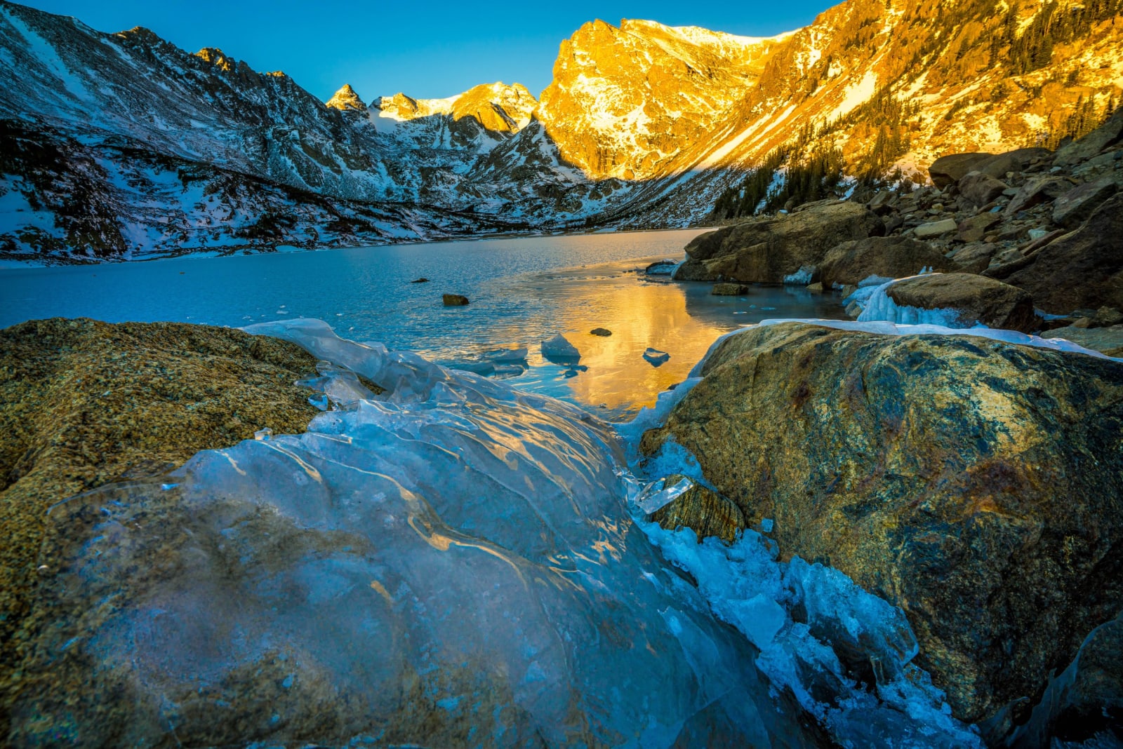 An Hour From the Shoreline — Indian Peaks Wilderness, Colorado. First light picking out the high ridge in blazing gold while the lake below stays locked in…