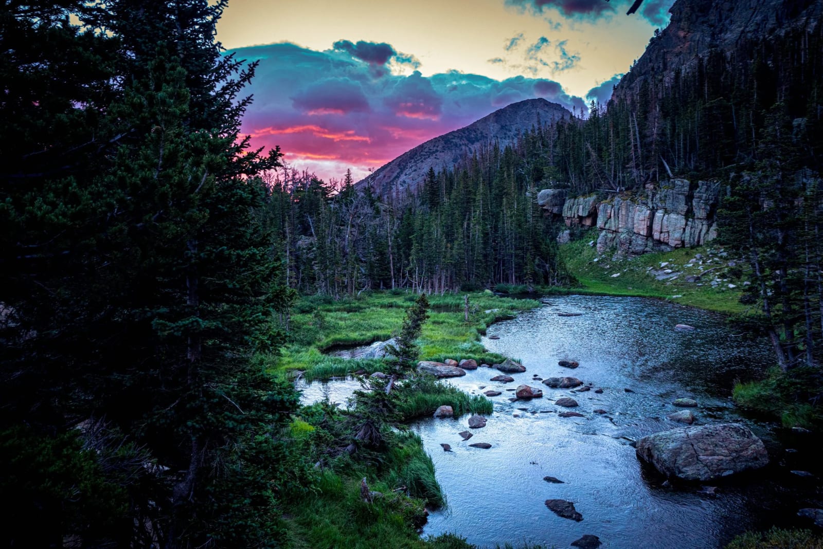 Ten Minutes to Headlamp — Rocky Mountain National Park, Colorado. The last pink of the day hanging over a quiet alpine tarn, dark spruce crowding both banks…