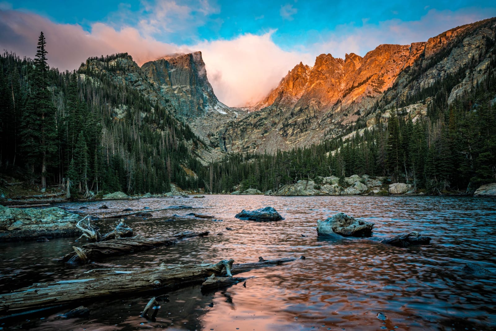 The Famous Logs, The Famous Peak — Rocky Mountain National Park, Colorado. The famous logs, the famous peak, and a sunrise doing its part at Dream Lake in…