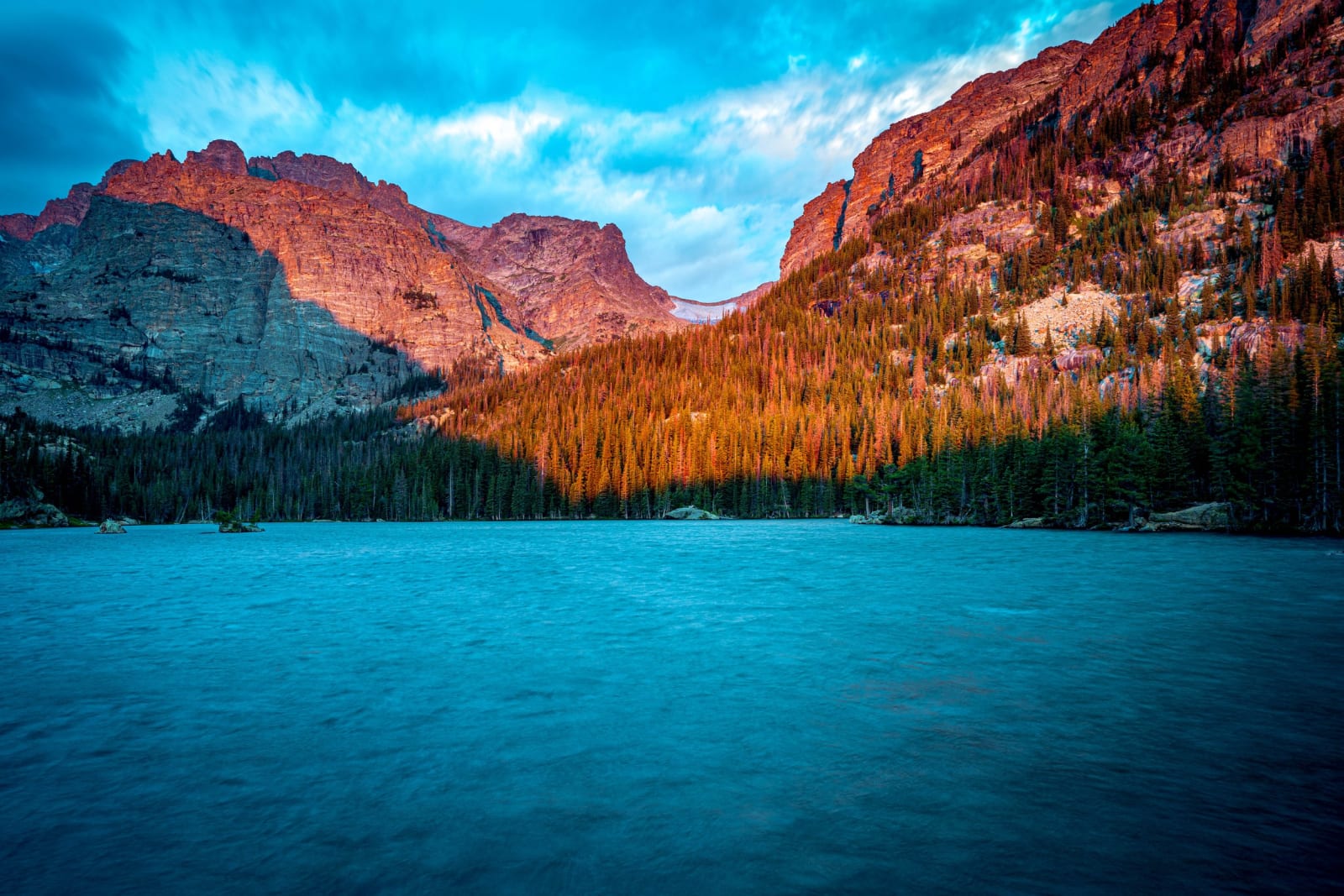 The Loch Warms Up — Rocky Mountain National Park, Colorado. First light working its way down the walls above The Loch in Rocky Mountain National Park,…