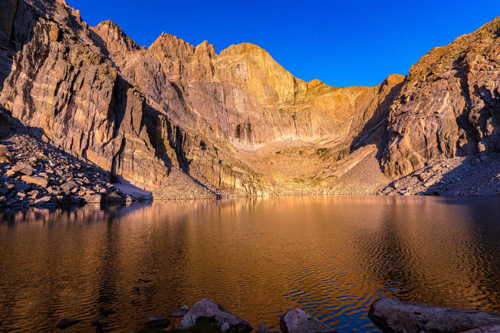 Sunrise Fills the Cirque — Rocky Mountain National Park, Colorado. Sunrise filling the cirque and spilling warm light across Chasm Lake below Longs Peak in…