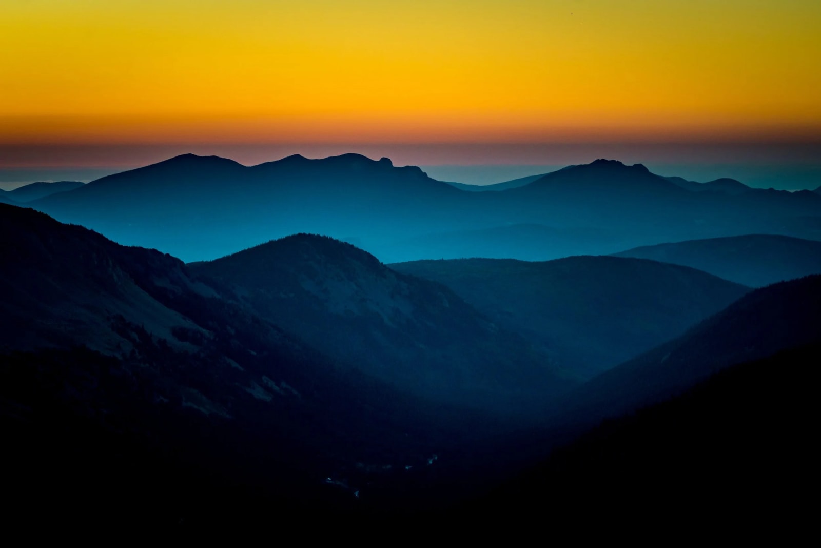 Paper Cutout Ridges — Chief Mountain, Colorado. Ridge after ridge fading into teal and shadow in the first light of morning, stacked out toward the…